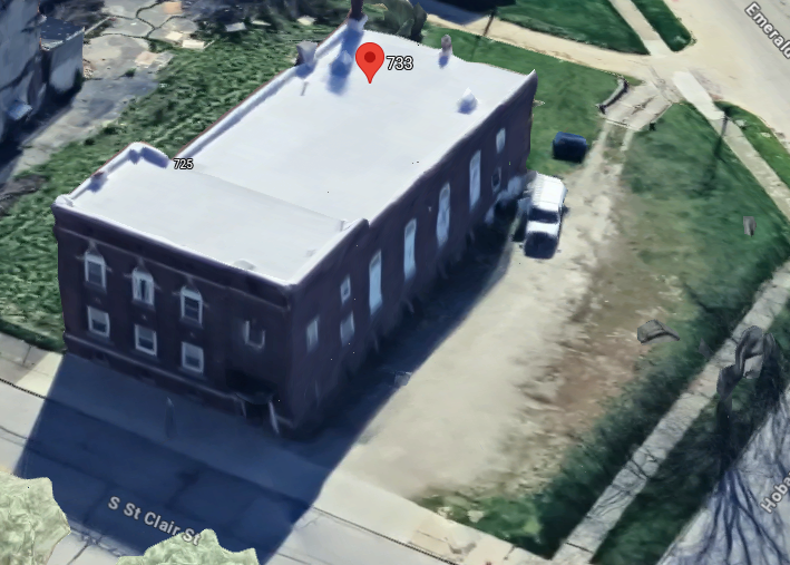 Overhead view showing the Holy Toledoan building and nearby parking